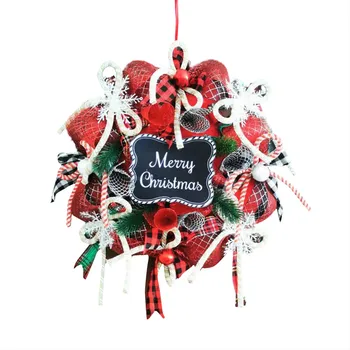 Рождественский венок, подвешенный на красочной веревке с узлами, поставляется с декоративной табличкой на двери 